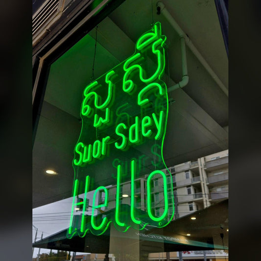 Green LED neon shop-window sign reading Suor Sdey and Hello, made from a customer's own artwork